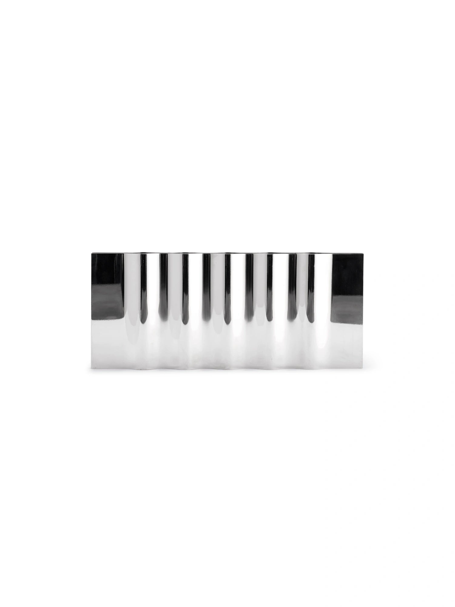 New Works Ripply Candle Holder, a modern polished silver metal rectangular design with wavy, ripple-like indentations, studio shot. Perfect for adding a premium, sculptural touch to any decor.