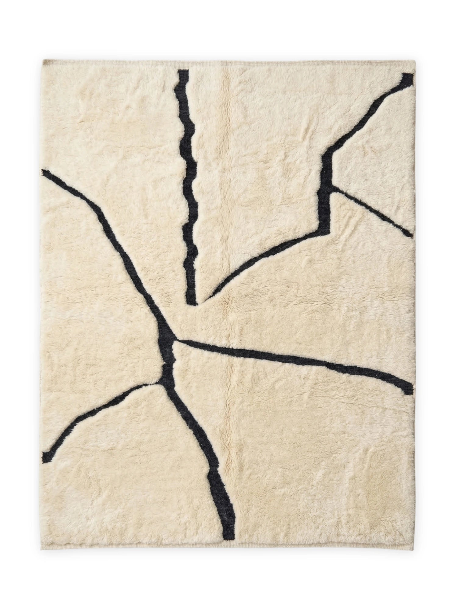 TCL Studios Script Wool Rug, a cream-colored hand-tufted wool area rug featuring bold, organic black abstract lines that resemble natural cracks or brushstrokes, creating a modern minimalist design. This plush, soft pile rug offers a luxurious texture and a striking high-contrast aesthetic. Perfect as a contemporary living room rug, a neutral bedroom accent, or a statement piece in an organic modern home office.
