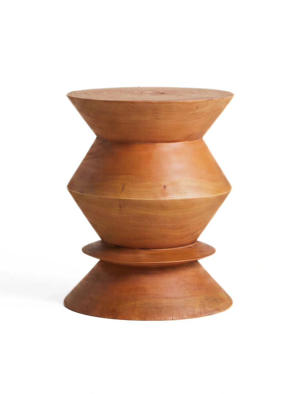 Heaps & Woods Thierry Stool, a hand-carved solid natural wood stool in a warm reddish-brown tone, featuring a distinctive hourglass or bobbin silhouette with a smooth finish and visible wood grain. This sculptural accent piece embodies organic modern and brutalist design, perfect as a side table or decorative stool for living rooms, bedrooms, or entryways.