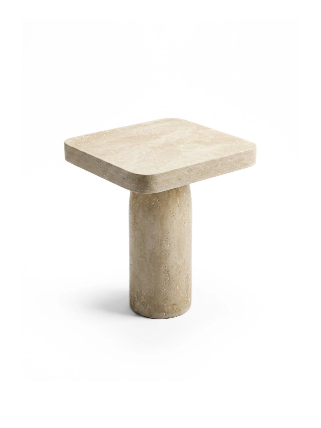 TCL Studios Tau Travertine Side Table, a minimalist natural stone accent table crafted from solid beige travertine with a porous texture and warm, earthy tones. It features a thick square top with gently rounded corners supported by a robust cylindrical base, embodying an organic modern design. Perfect as a contemporary side table for living rooms, bedrooms, or entryways.