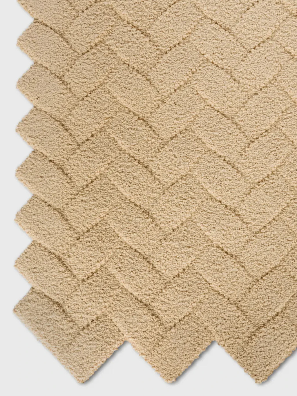 alp_ Palma Rug, a textured beige area rug crafted with a plush looped pile that creates a raised geometric herringbone pattern in warm, natural sand tones. This soft bouclé rug offers a cozy, organic modern aesthetic, perfect for minimalist living rooms or contemporary bedrooms.