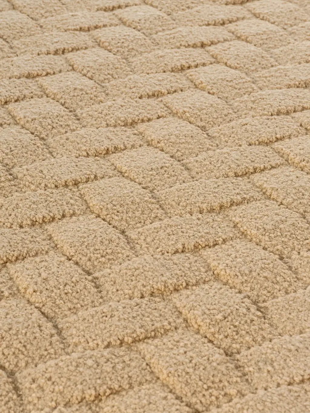 alp_ Palma Rug, a natural beige wool area rug with a highly textured, plush loop pile that forms a distinctive, raised basketweave pattern.