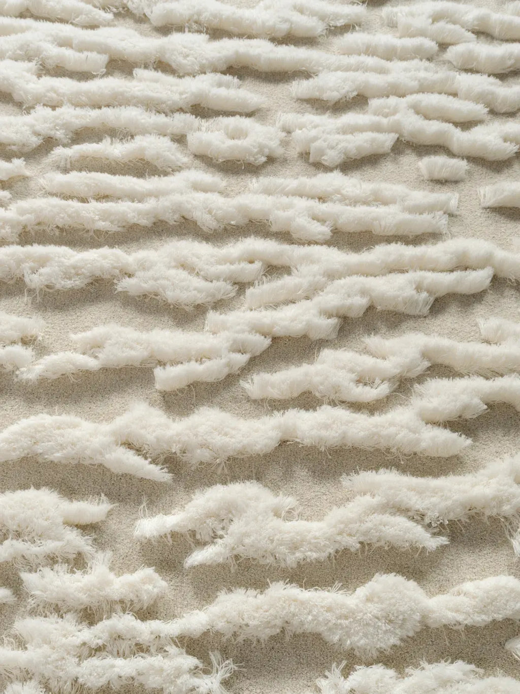 alp_ Plage Sauvage Rug, a plush organic modern area rug featuring a high-low pile with a shaggy, cloud-like cream texture against a subtly looped ivory base. This natural wool blend rug creates a cozy, inviting feel with its rich tactile dimension. Perfect for a Scandinavian living room, boho bedroom, or minimalist nursery seeking a warm, textural accent.