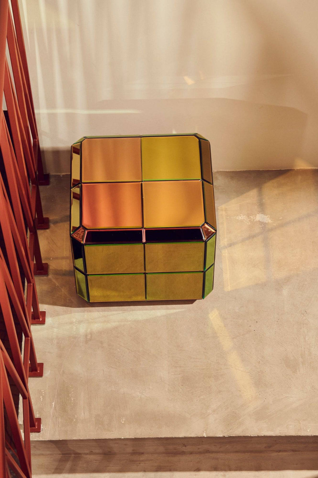 POLSPOTTEN Pixel Coffee Table, a contemporary multi-colored mirrored glass coffee table featuring an iridescent finish that shifts between warm amber, orange, yellow, and green tones. This striking geometric cube design is composed of faceted mirrored panels, creating a dynamic and reflective surface. Ideal as a glamorous statement piece for modern living rooms or eclectic interior designs.