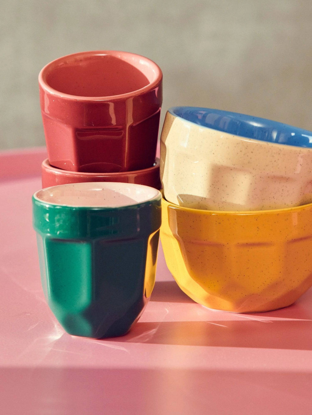 POLSPOTTEN Espresso Mug - Set of 4, featuring a stylish, modern design with a vibrant color palette of red, green, yellow, and blue. These handcrafted ceramic mugs have a unique faceted shape and a glossy finish, perfect for adding a touch of playful elegance to any kitchen. Ideal for coffee lovers seeking durable and chic drinkware.