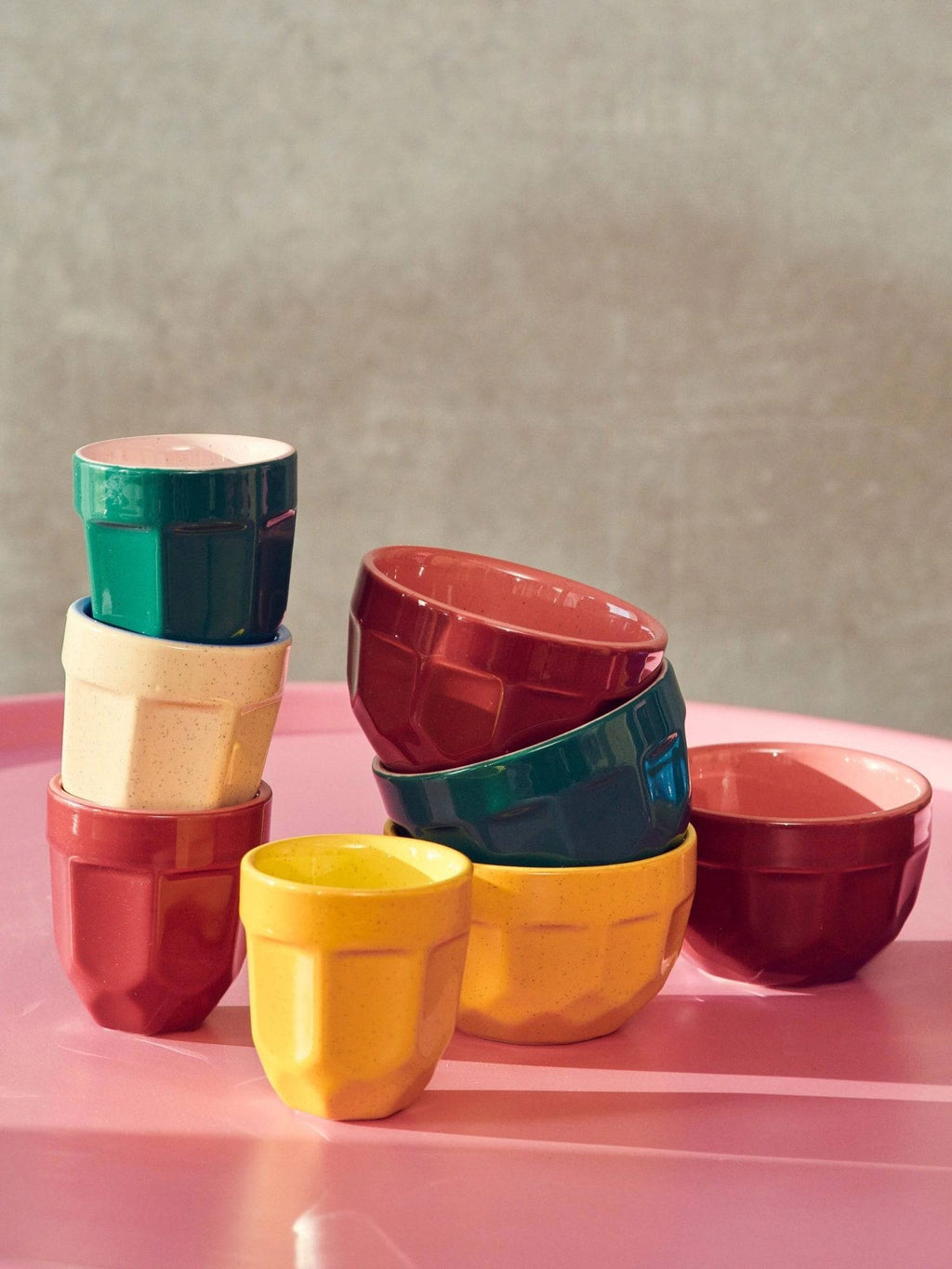 POLSPOTTEN Espresso Mug - Set of 4, featuring durable ceramic in vibrant colors like red, yellow, green, and deep pink. These stylish mugs boast a unique faceted design and a speckled finish, adding a modern touch to any kitchen. Perfect for coffee lovers seeking elegant and durable drinkware.