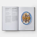 Close-up of Portugal: The Cookbook open to a page of seafood recipes