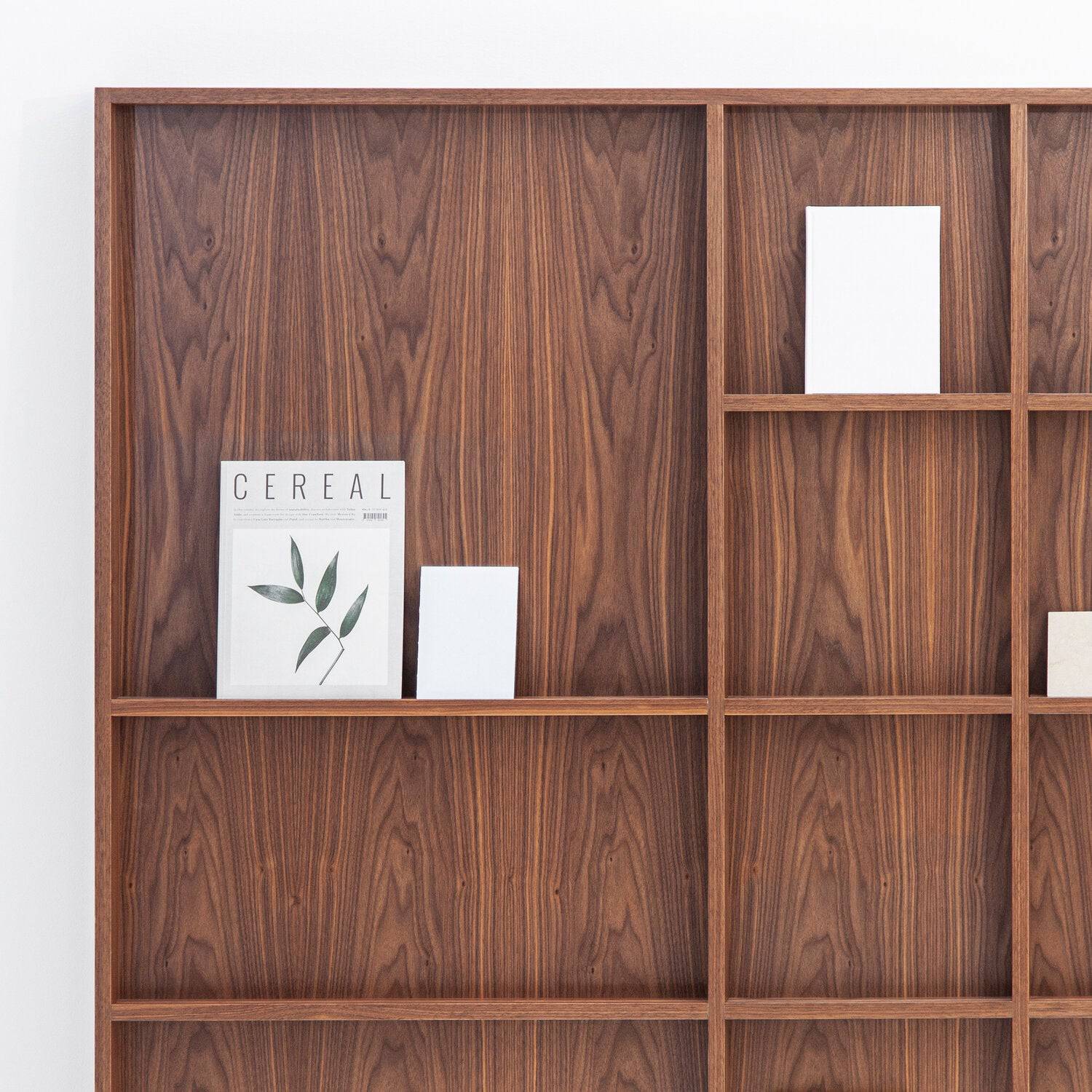 Porventura Atlas Wall Cabinet, a modern minimalist wall cabinet crafted from rich dark solid walnut wood, featuring a sleek grid-like modular shelving design with clean lines and visible wood grain. This contemporary walnut shelving unit is ideal for stylish display and media storage in living rooms, home offices, or dining areas.