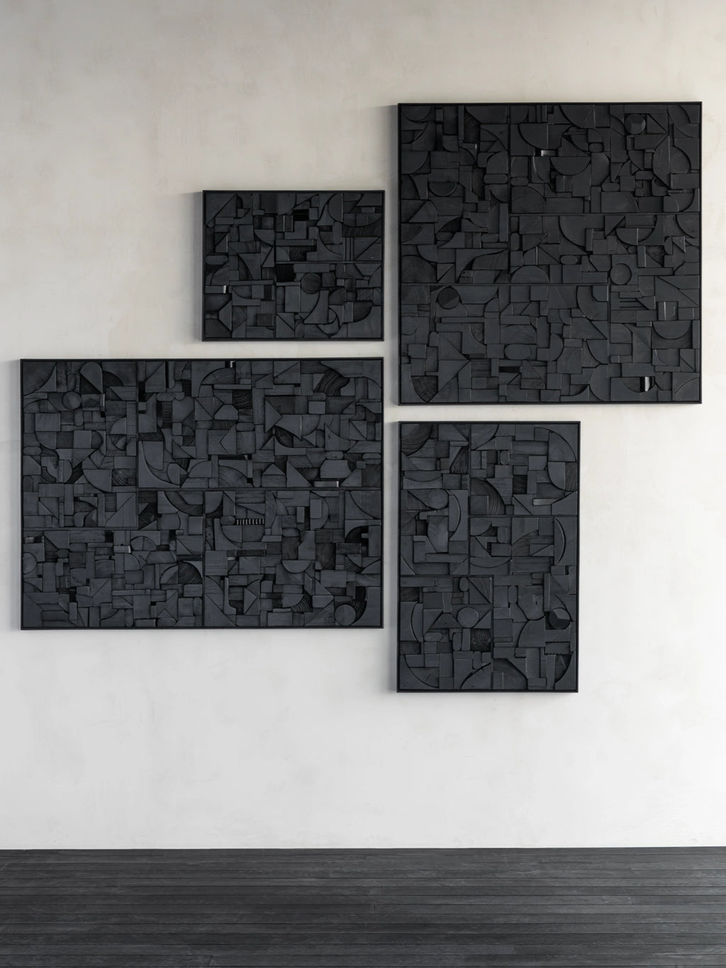 Ethnicraft Bricks Wall Art, a collection of dark matte black solid wood wall panels featuring a high-relief abstract geometric design.