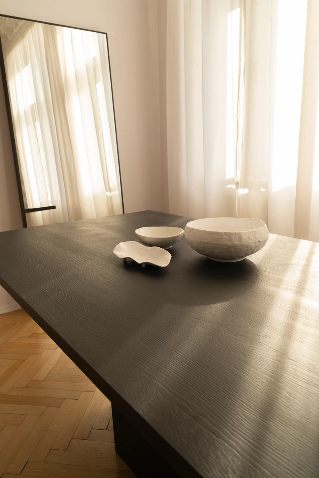 NG DESIGN Object 056 Dining Table, featuring a rectangular dark ash wood top with visible grain, styled with three artisanal white ceramic bowls. This luxury minimalist table effortlessly elevates any contemporary dining space.