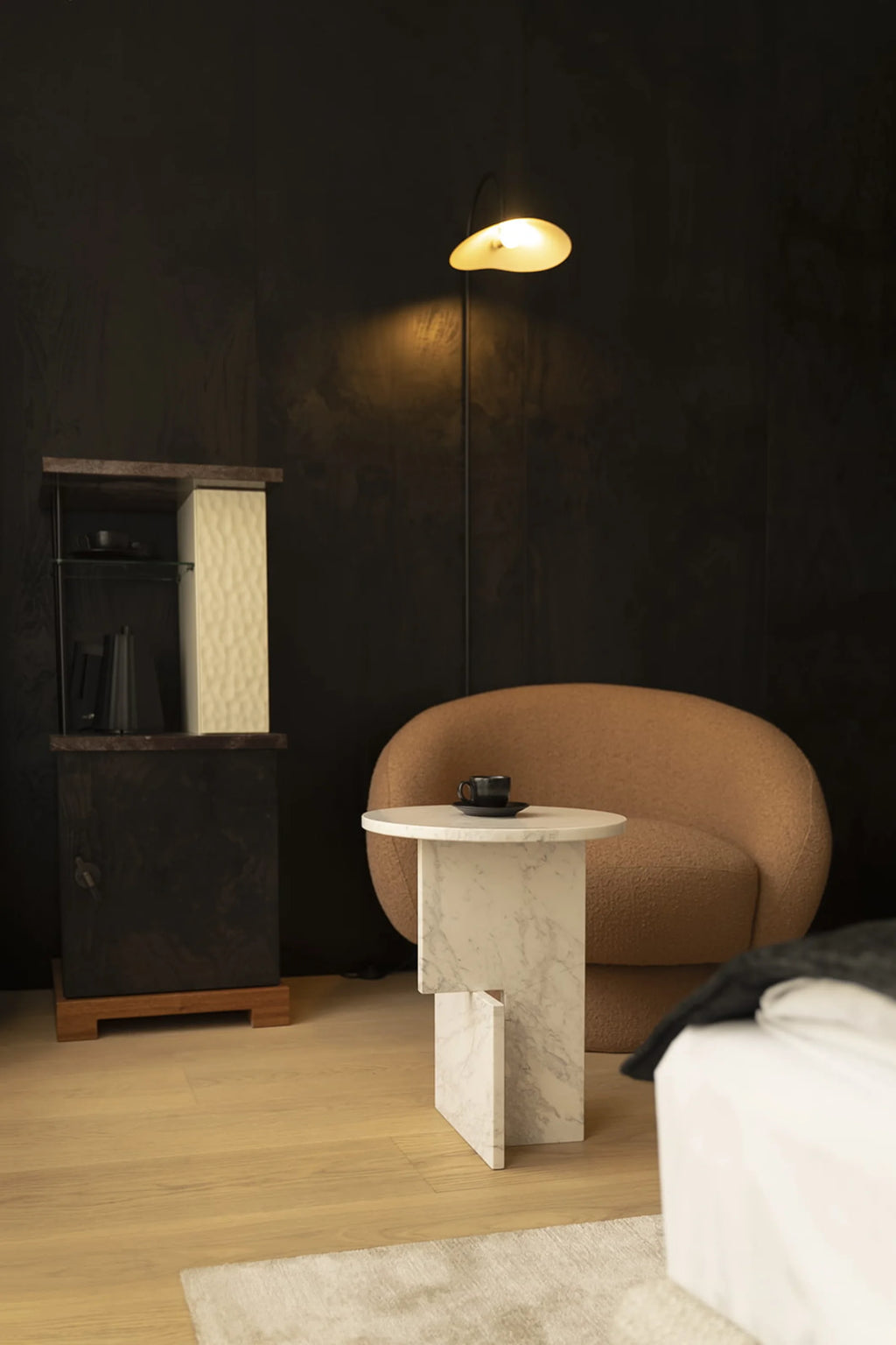 NG DESIGN Object 065 Side Table: a luxurious white marble modern side table with a unique rectangular base, featuring a black cup on top, styled next to a brown armchair. Ideal for contemporary living spaces.