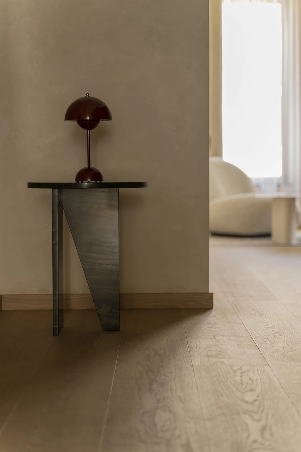 NG DESIGN Object 066 Side Table, a sleek black metal modern console table with an asymmetrical angled leg, showcasing a premium, minimalist design displayed in a stylish interior. Perfect for a chic entryway or living room.