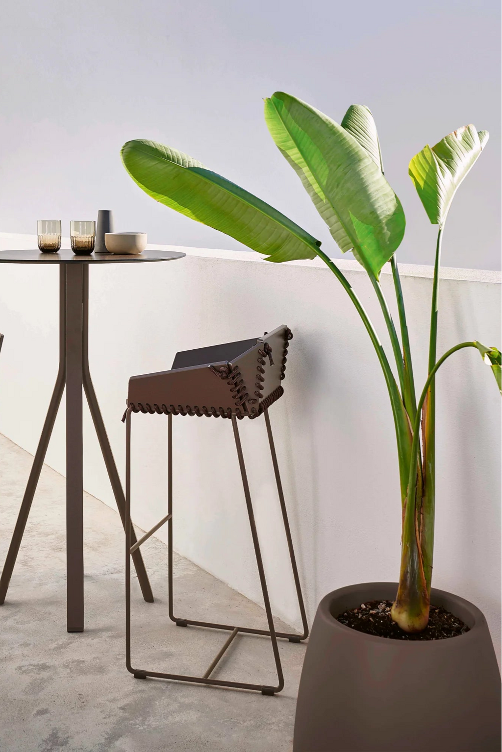 Gandia Blasco Sahara Outdoor Planter 2, a modern minimalist rotation-moulded polyethylene planter featuring a smooth, matte dark brown finish and a sleek, tapered shape that widens towards the top.