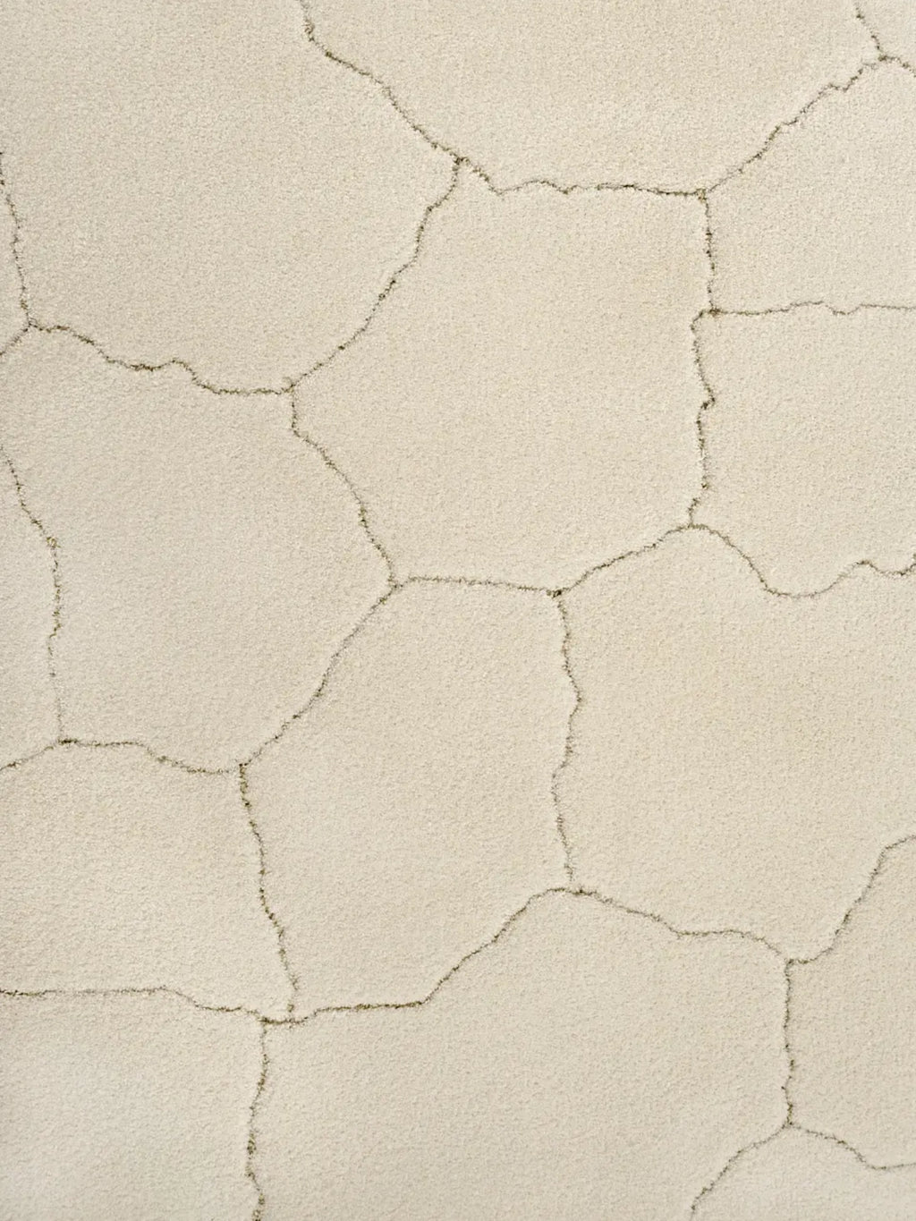 alp_ Saline Rug, a plush cream area rug featuring an organic, abstract cracked earth pattern in contrasting dark grey lines over a soft, high-pile ivory texture. This contemporary and natural-inspired rug offers a cozy feel and distinctive design, perfect for adding an organic modern touch to minimalist living rooms, Scandinavian bedrooms, or boho-chic spaces.