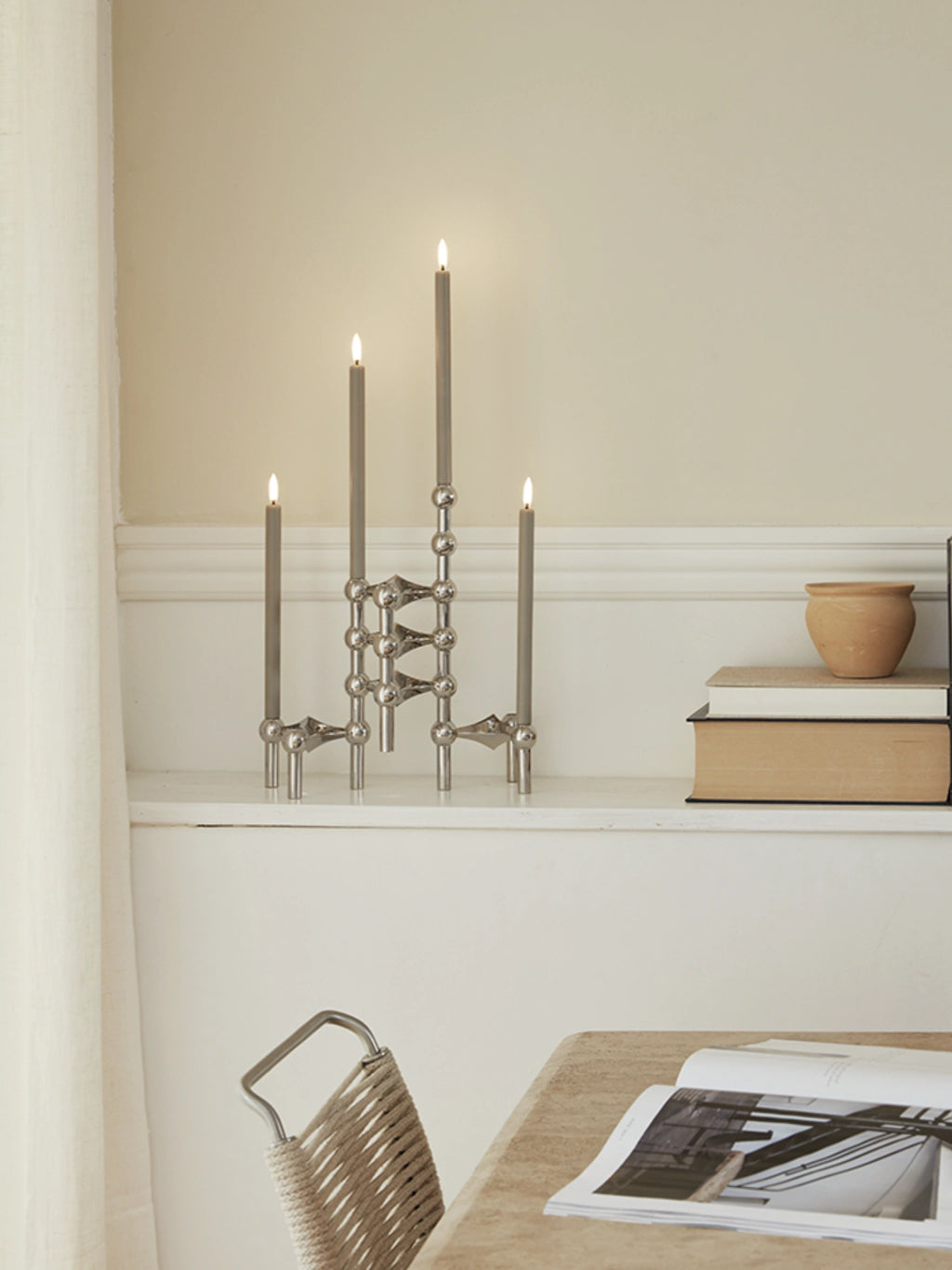 Stoff Nagel LED Candles - Set of 2, elegant grey battery-operated taper candles designed with a realistic wax-like finish and a warm, flickering LED flame. These modern minimalist flameless candles offer a safe and stylish alternative to traditional candles. Ideal for complementing Stoff Nagel candelabras, dining table centerpieces, or cozy shelf styling in any contemporary living space.