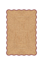 Beige braided rug with a scalloped edge on a white background