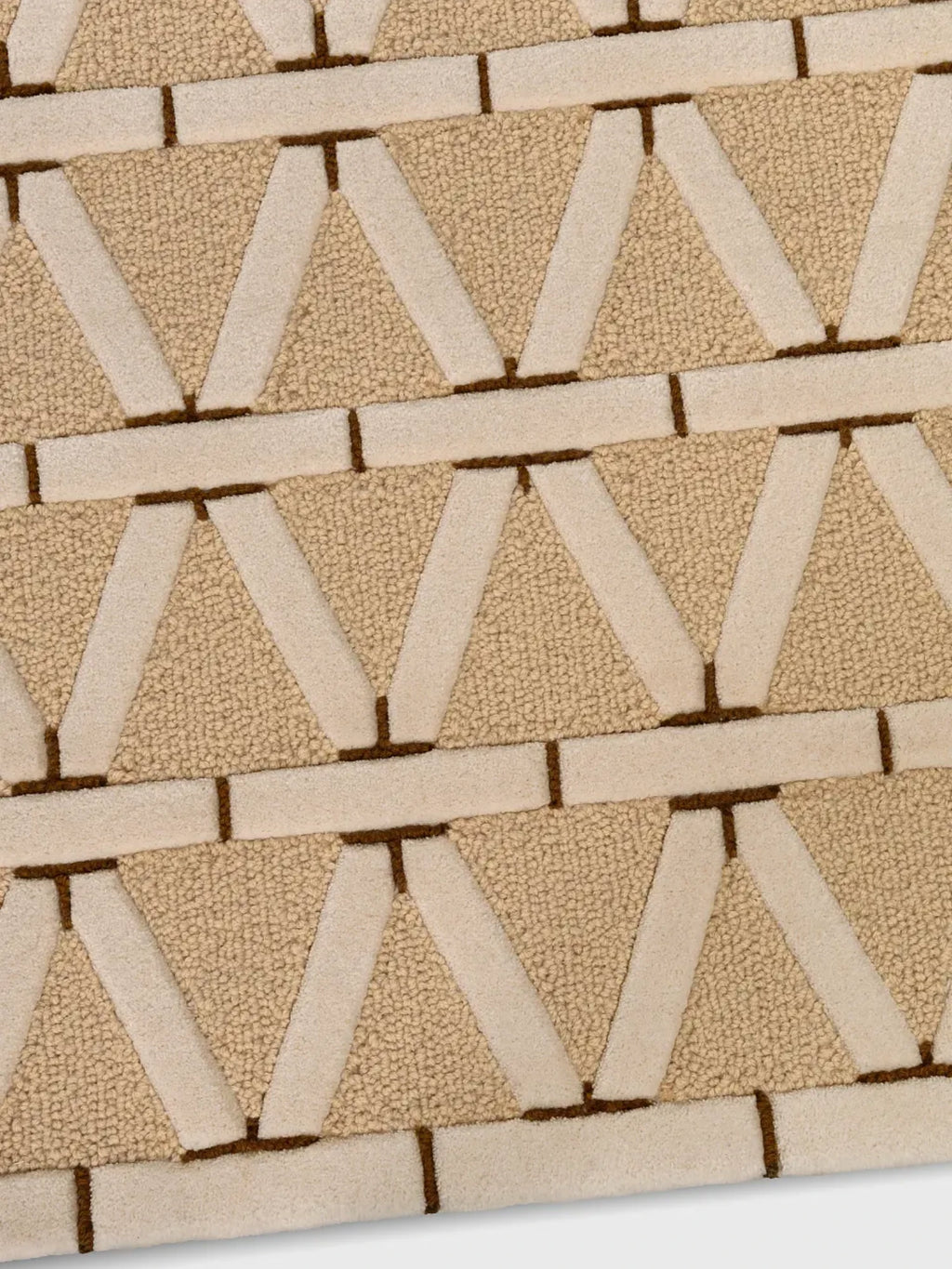 alp_ Secadero Rug, a contemporary hand-tufted wool rug featuring a geometric triangle and bar pattern in natural beige, cream, and dark brown tones. This textured area rug has varied pile heights, combining plush loop pile and soft cut pile for a rich tactile experience. Perfect for modern living rooms, minimalist bedrooms, or organic modern interiors.