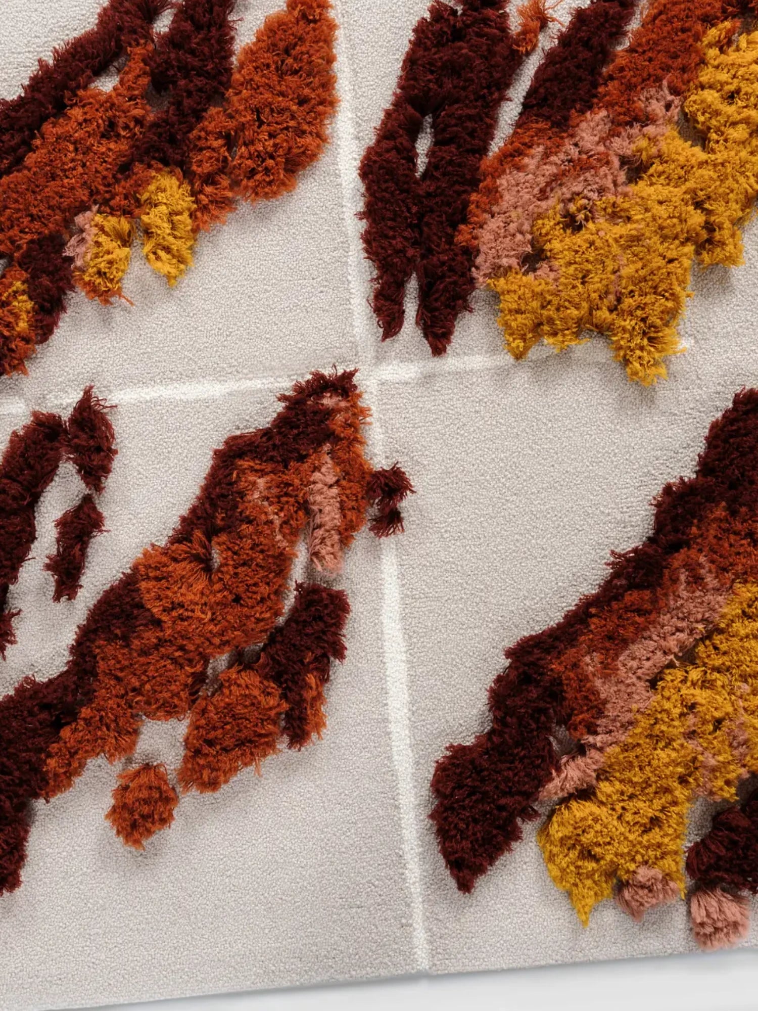 alp_ Séquence Tapestry, a contemporary handcrafted tufted wool wall hanging featuring abstract organic shapes in rich burgundy, burnt orange, mustard yellow, and soft peach tones on a light grey background.