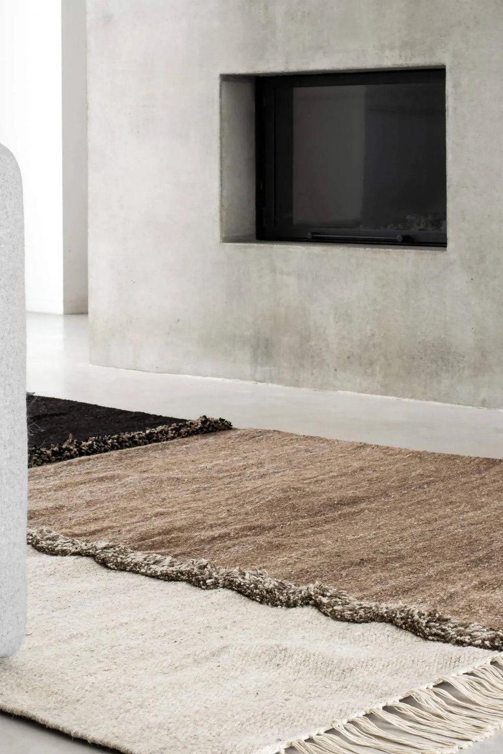 Sera Helsinki E-1027 Wool Rug, a premium hand-knotted wool area rug featuring a multi-tone design with blocks of natural undyed cream, warm brown, and dark charcoal wool, separated by a plush, shaggy textured.