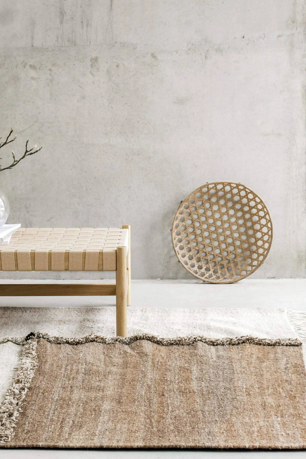 Sera Helsinki E-1027 Wool Rug, a hand-knotted wool area rug featuring a distinctive two-tone design with natural undyed cream and warm beige sections, separated by a plush, shaggy textured stripe. This organic modern rug offers a soft, cozy feel and minimalist aesthetic, perfect for Scandinavian living rooms, japandi bedrooms, or rustic contemporary spaces.