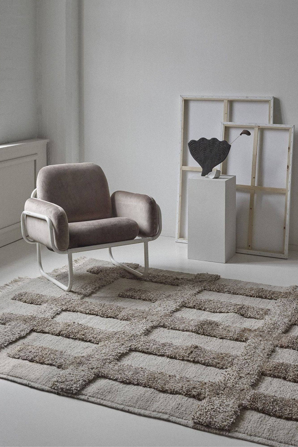 Sera Helsinki Valli Wool Rug, a premium hand-knotted wool area rug in soft light grey and greige tones, featuring a unique raised geometric pattern with a plush, high-pile texture against a lower-pile base. This contemporary natural wool rug offers a cozy, organic modern feel, perfect for Scandinavian living rooms, minimalist bedrooms, or stylish home office spaces.