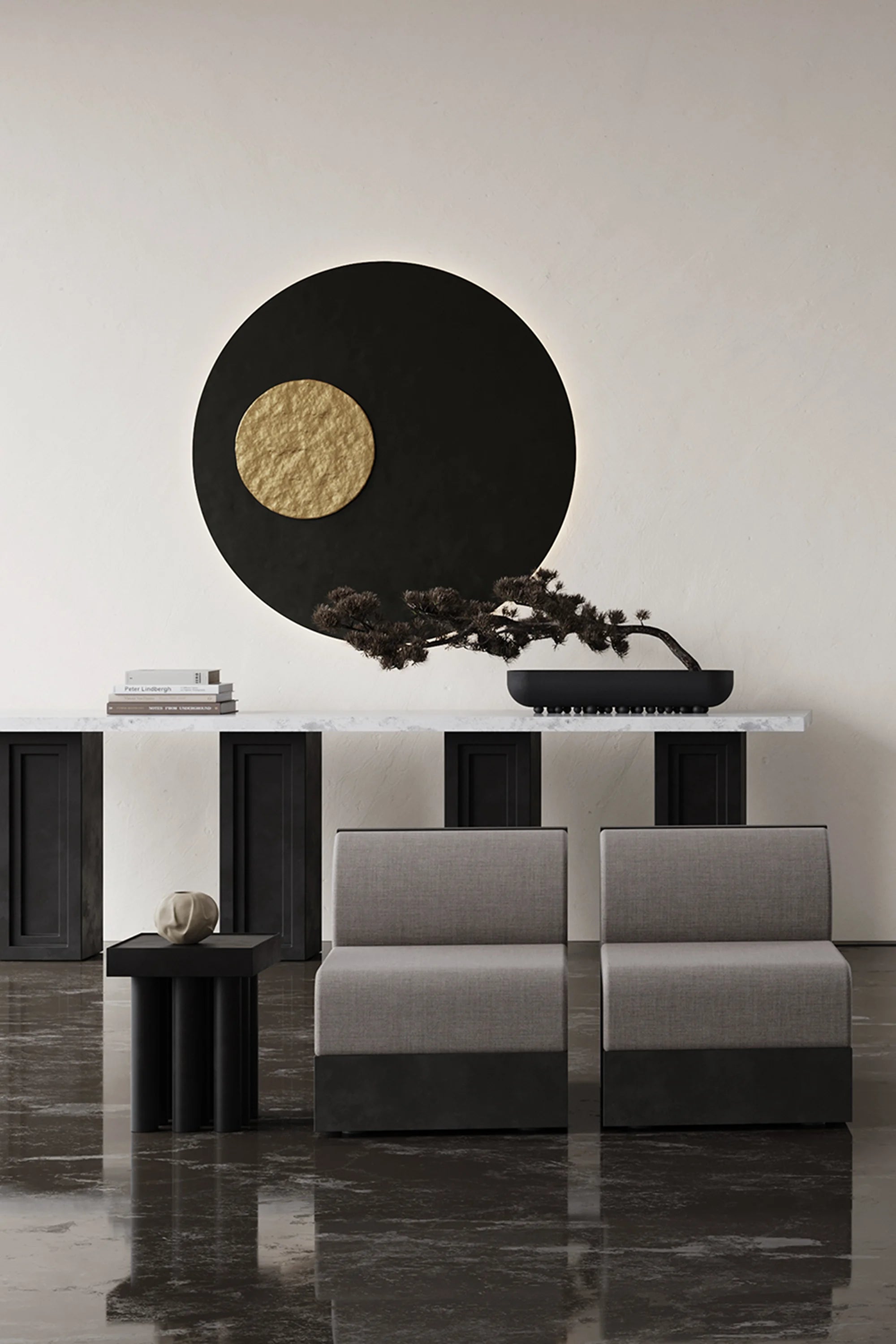 Modern interior with a black and gold circular artwork on a white wall.