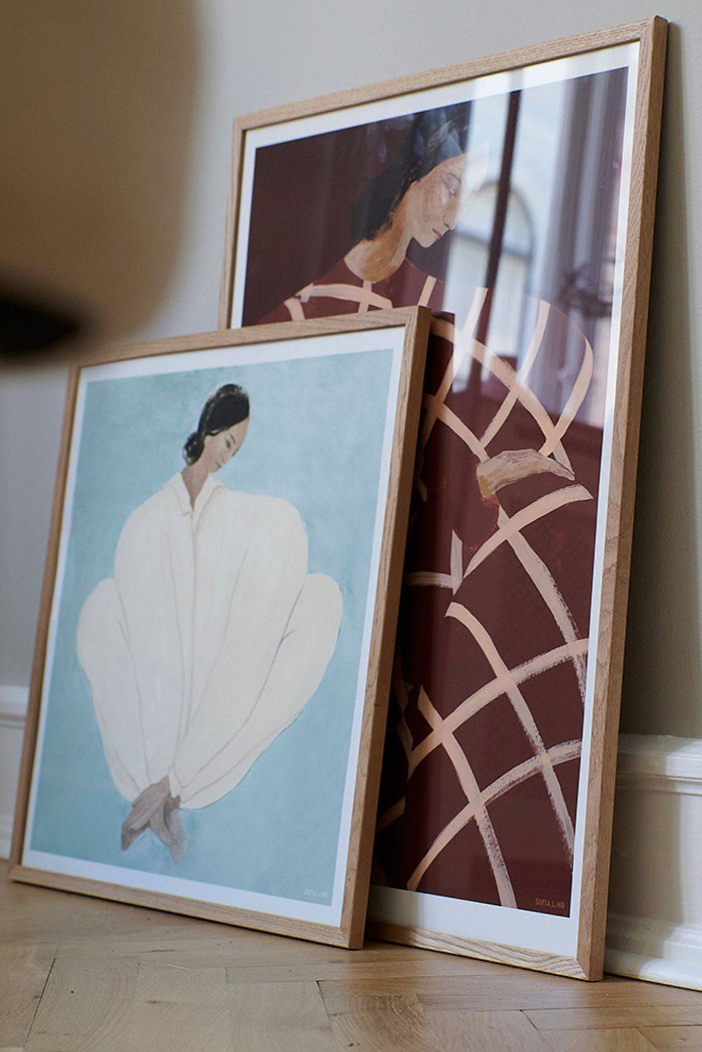 The Poster Club Waiting At Art Et Métiers, a contemporary abstract figurative art print depicting a woman in profile, rendered in rich dark reddish-brown hues with an expressive light peach grid pattern across her dress.