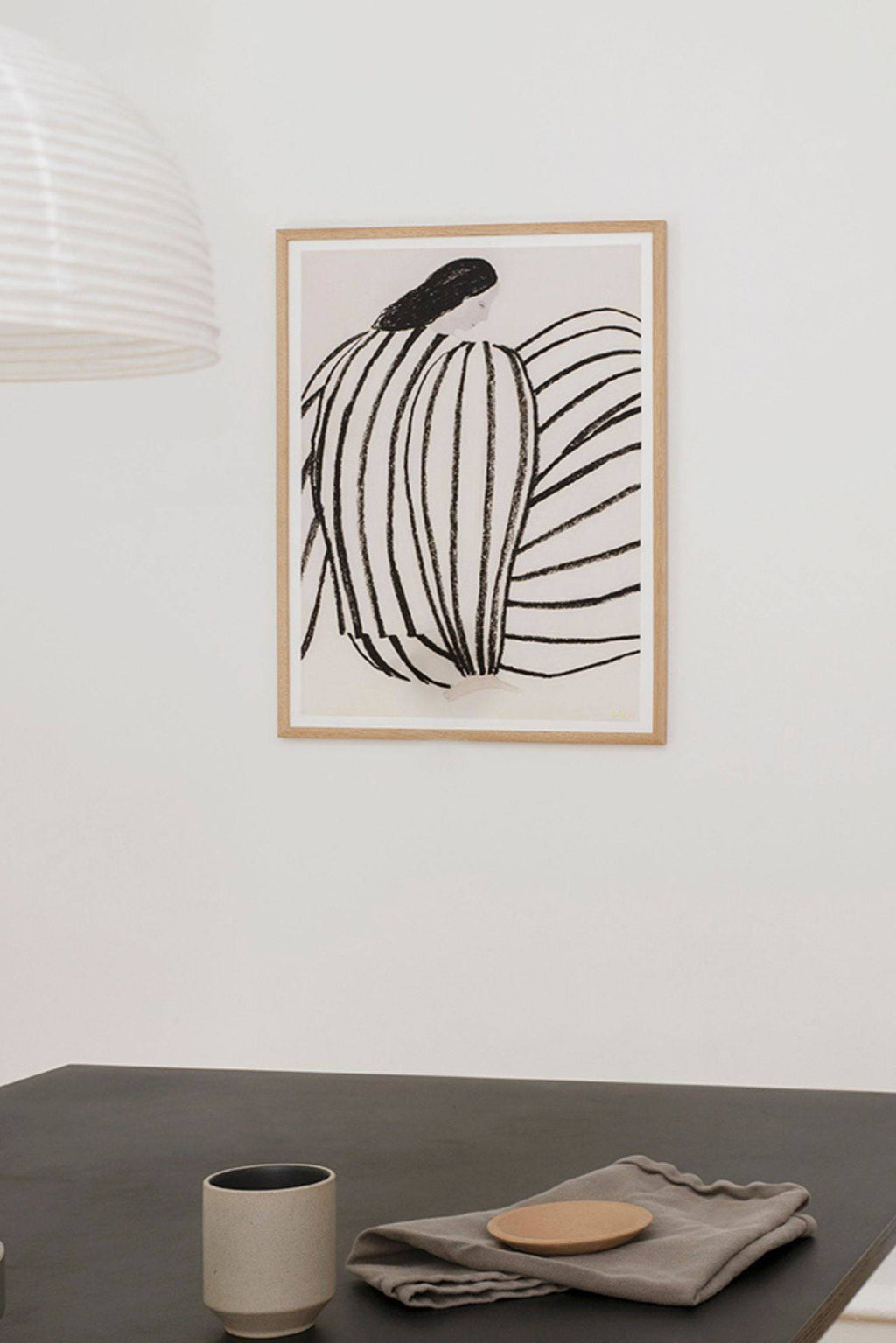 The Poster Club You, a minimalist abstract art print featuring an organic figurative drawing with bold, textured black lines on a creamy off-white background. This contemporary art poster is framed in a light natural oak frame with a crisp white mat, enhancing its clean aesthetic. Ideal as modern wall art for Scandinavian living rooms, minimalist bedrooms, or gallery wall styling.