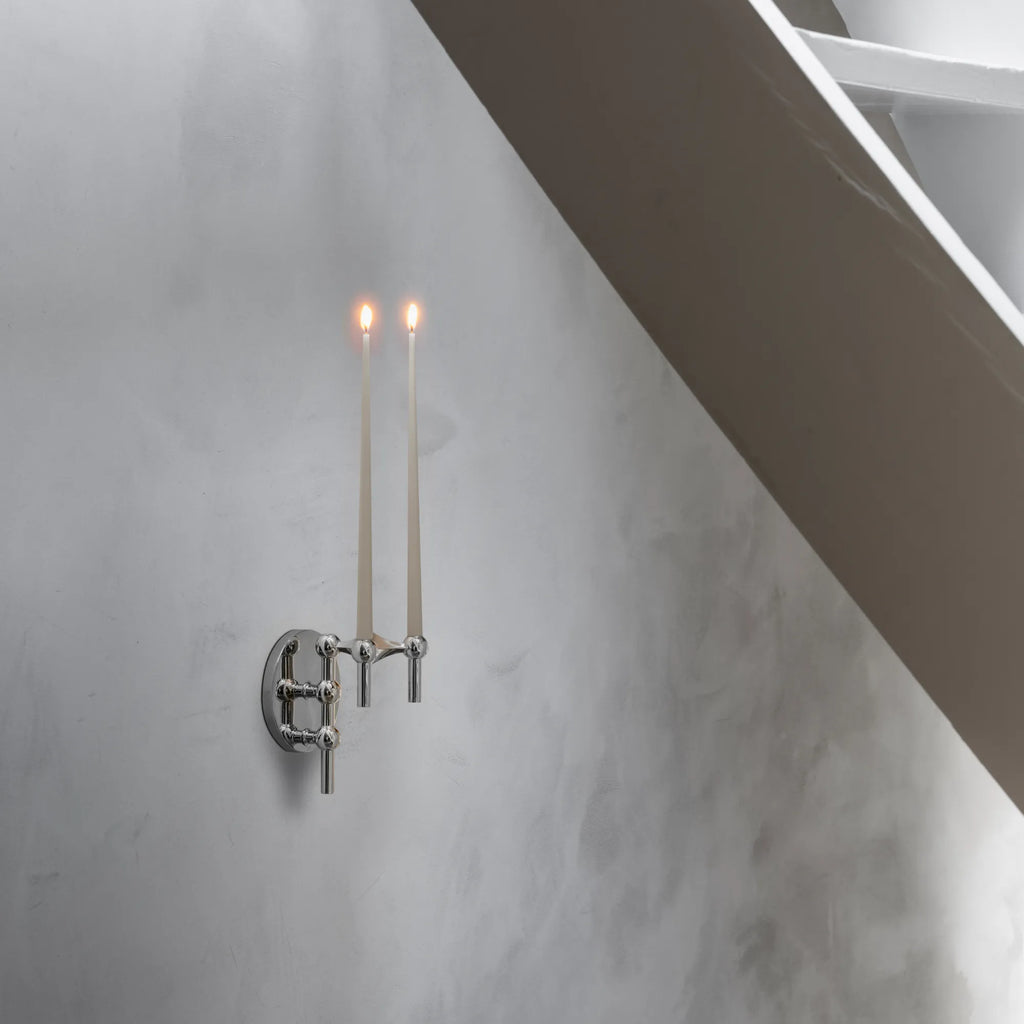 Stoff Nagel Wall Hanger Candle Holder - Chrome - Configuration 3, a sleek mid-century modern wall-mounted candle holder crafted from polished chrome with a modular, sculptural design featuring spherical joints and two holders for taper candles. This iconic Danish design piece provides elegant accent lighting, perfect for minimalist living rooms, entryways, or contemporary stairwell decor.