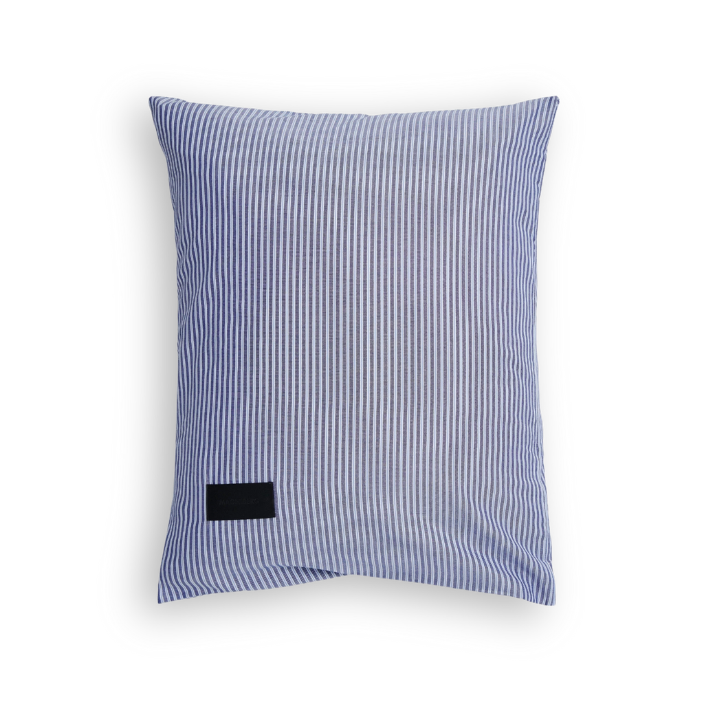 Magniberg Wall Street Pillow Case - Stripe Dark Blue, a classic rectangular pillowcase featuring a crisp dark blue and white vertical stripe pattern on premium woven cotton fabric, complete with a subtle black brand tag. This versatile bed linen is ideal for sophisticated bedroom decor, modern minimalist bedding, or Scandinavian-inspired sleeping spaces.