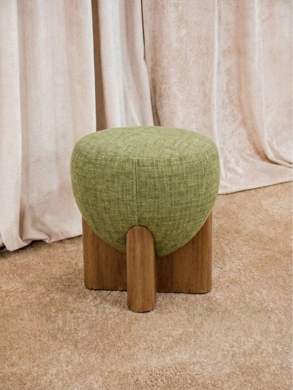 TCL Studios Grove Pouf, an organic modern upholstered ottoman featuring a rounded, plush cushion in a textured olive green fabric with a subtle woven pattern.