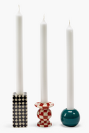 Three candles in decorative candle holders on a white background