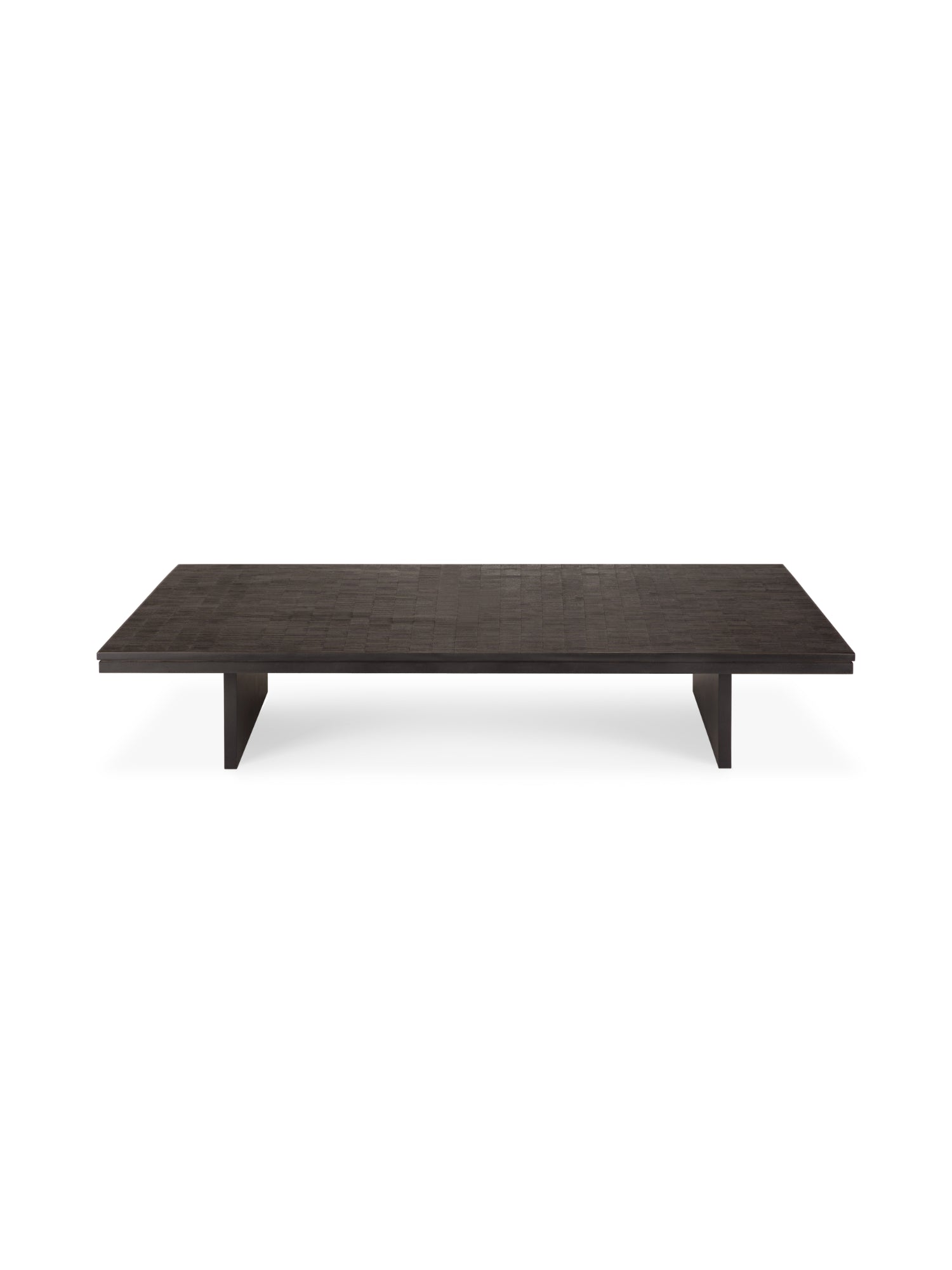 Ethnicraft Grooves Coffee Table, a low, rectangular design crafted from varnished Off-Black teak wood, featuring a textured surface with subtle linear grooves and two robust block legs, presented on a white background.