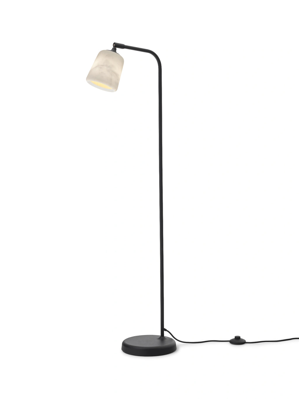 New Works Material Floor Lamp, a modern minimalist standing lamp featuring a sleek matte black metal frame with a slender curved arm and a round base, topped by a translucent white alabaster shade with natural grey ve.