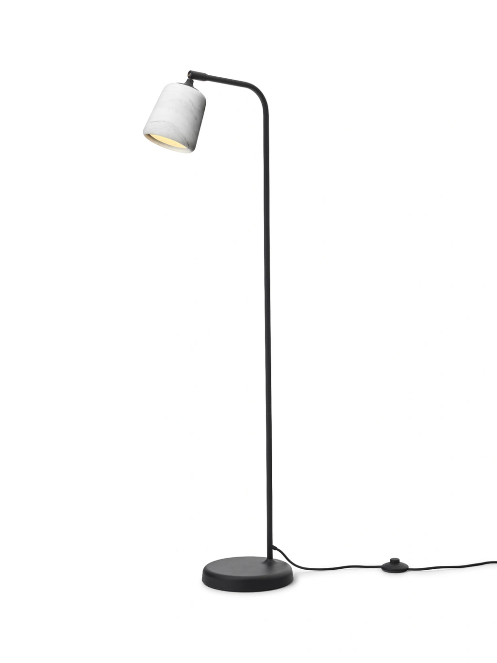 New Works Material Floor Lamp, a modern minimalist floor lamp featuring a cylindrical white marble shade with subtle grey veining, gracefully balanced on a slender matte black metal stem, curved arm, and round flat base. This elegant contemporary floor lamp provides warm ambient light, ideal for Scandinavian living rooms, organic modern bedrooms, or cozy reading nooks.