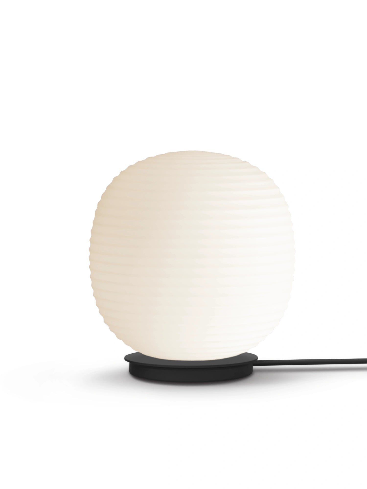 New Works Lantern Globe Floor Lamp with a large, textured ivory white rice paper shade and a sleek black circular base on a white background. This unique, authentic design provides elegant ambient lighting.