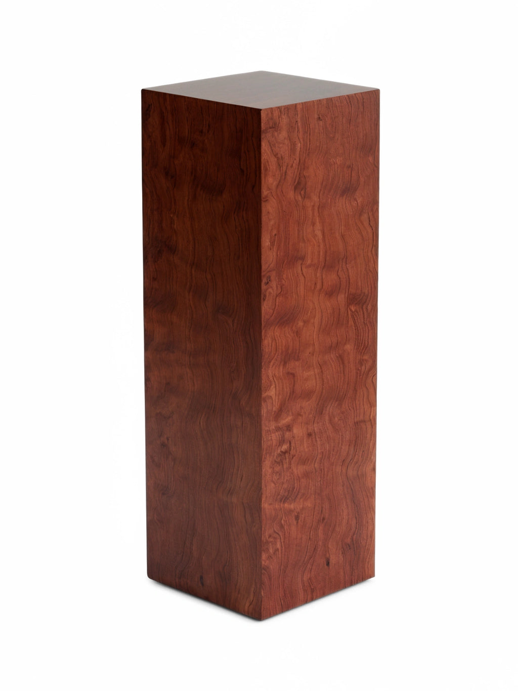 TCL Studios Monolith Pomele Display Column, a sleek modern minimalist display column crafted from rich reddish-brown pomele wood, showcasing a distinctive wavy figured grain and a polished, smooth finish. This contemporary rectangular wood pedestal functions perfectly as a sculptural side table, elegant plant stand, or art display column for design-conscious living rooms, entryways, or upscale commercial spaces.