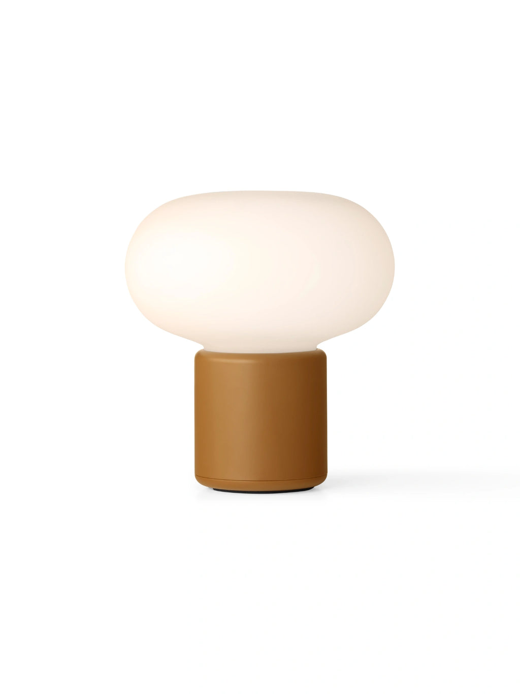 New Works Karl-Johan Portable Table Lamp on white background, featuring a mushroom-shaped opaque white glass shade and a matte caramel brown cylindrical base. A premium modern design accent. Ideal for task lighting.