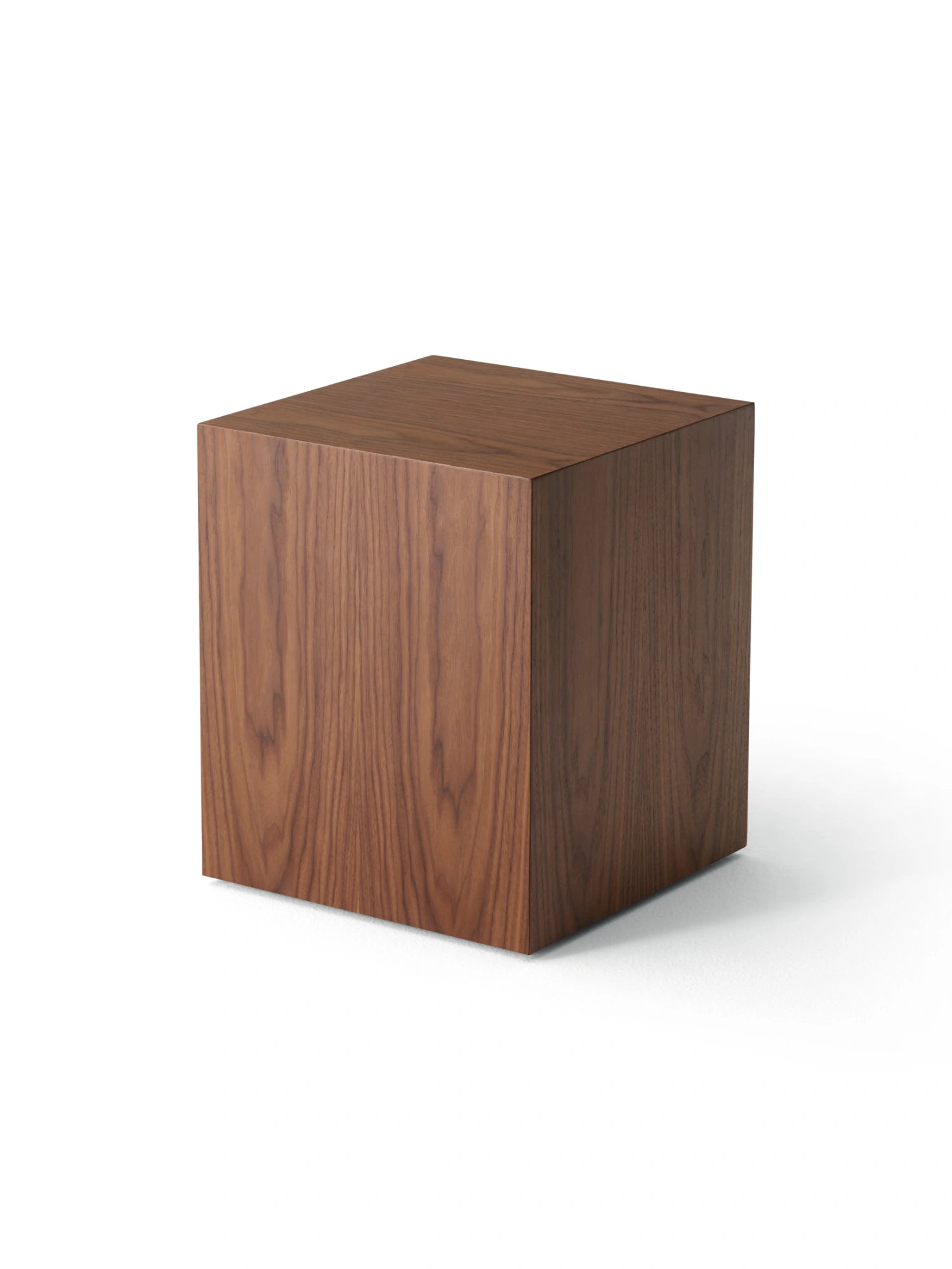 New Works Mass Side Table, a modern minimalist side table with a striking cube silhouette, crafted from dark walnut wood veneer with a rich brown finish and visible natural wood grain texture. This versatile geometric plinth functions perfectly as a contemporary end table for living rooms, a Scandinavian bedside table, or a sleek pedestal for displaying decor in minimalist interiors.