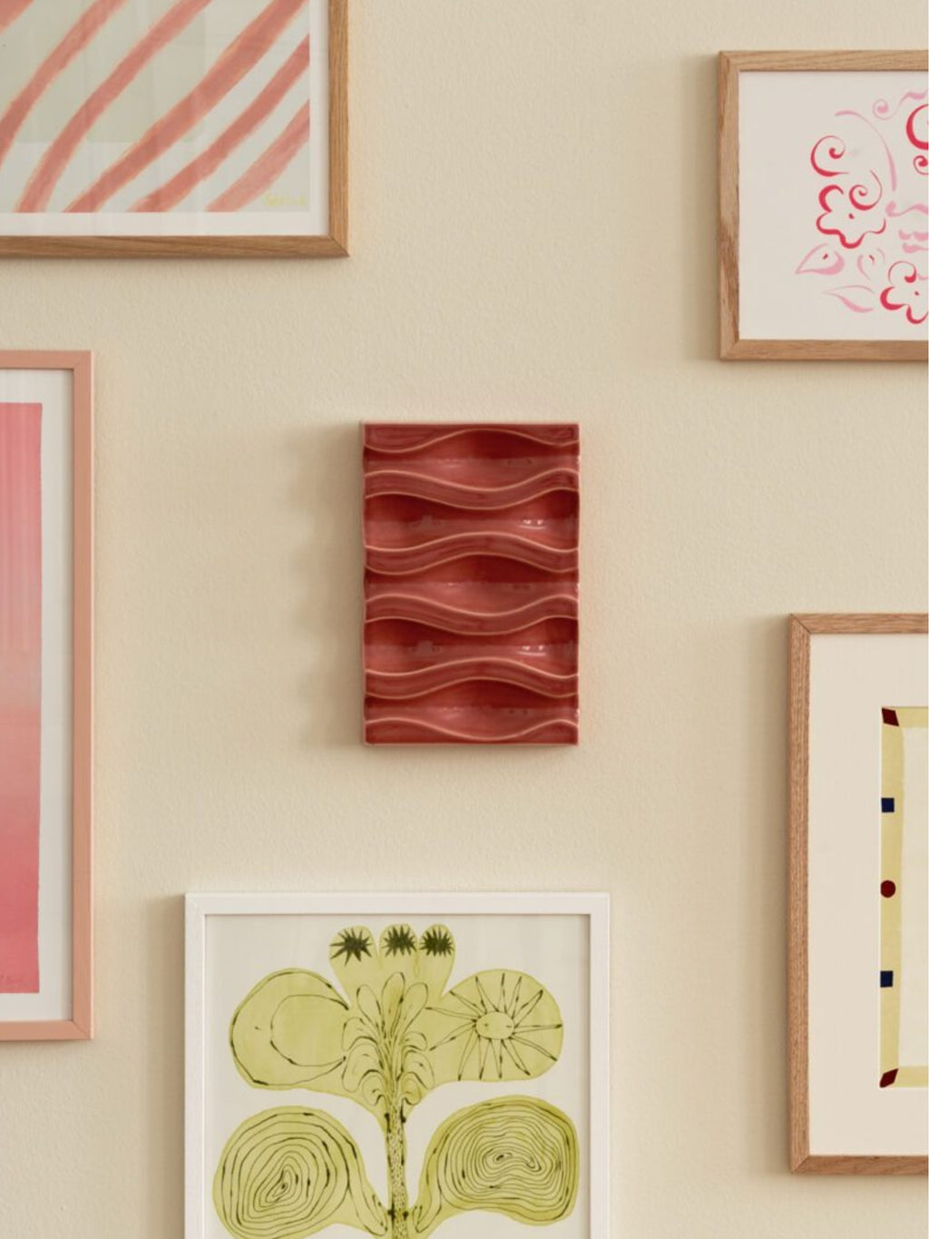 The Poster Club Echo Relief No. 02, a rectangular ceramic wall relief in a rich terracotta red hue with a glossy finish and distinctive wavy, undulating texture. This organic modern wall art piece features a series of horizontal ridges, creating a dynamic three-dimensional surface. It's ideal for adding a contemporary ceramic accent to a gallery wall, living room, or minimalist entryway.