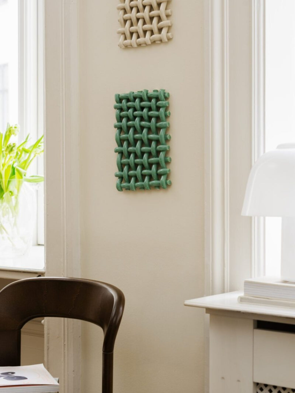 The Poster Club Interlace No. 02, a contemporary sculptural wall art piece featuring a matte sage green finish and a deeply textured, interlocked woven pattern, creating a captivating 3D.