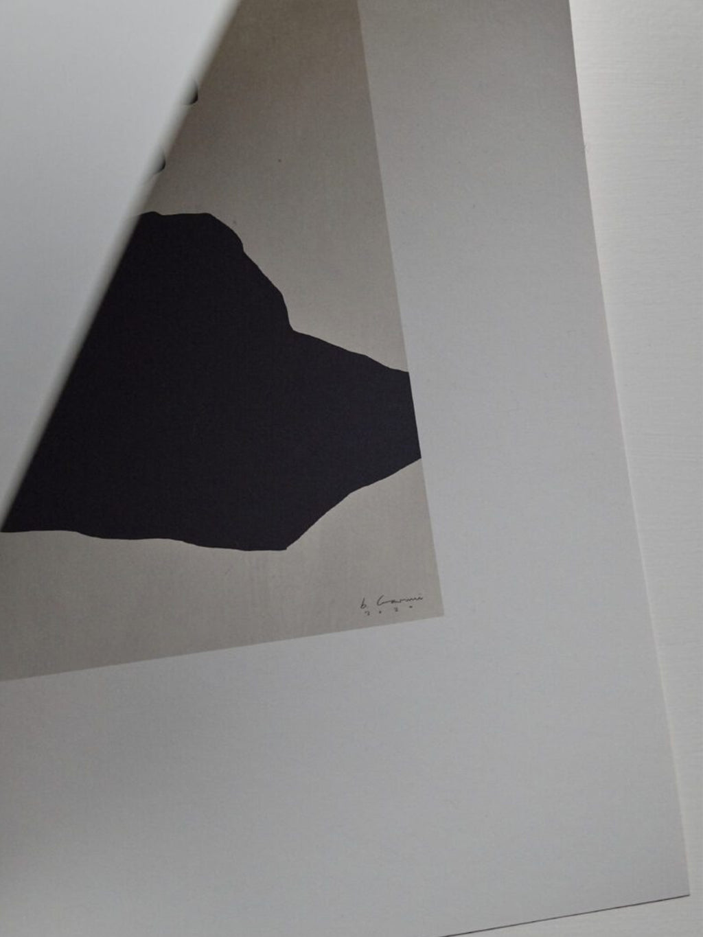 The Poster Club STATIC 02, a minimalist abstract art print featuring a bold, irregular black organic shape against a subtle light beige background, framed by a clean white border. This contemporary wall art is ideal for modern gallery walls, Scandinavian living rooms, or minimalist bedroom decor.