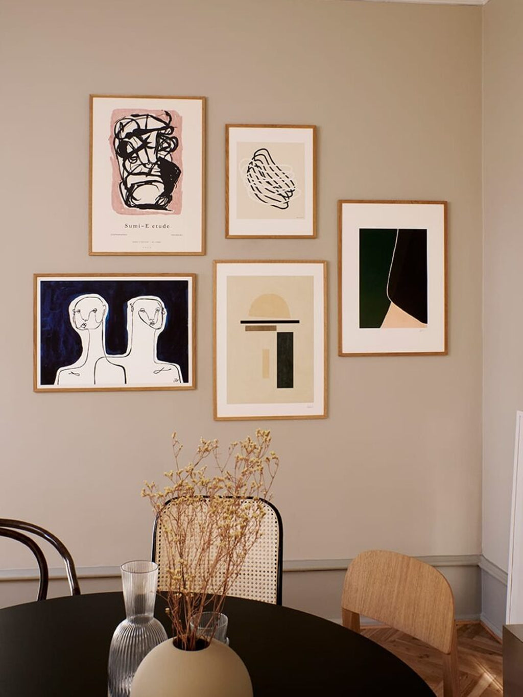 The Poster Club Sumi e 03, a modern abstract art print featuring bold black graphic brushstrokes on a blush pink background, framed with a crisp white mat and a light natural oak.