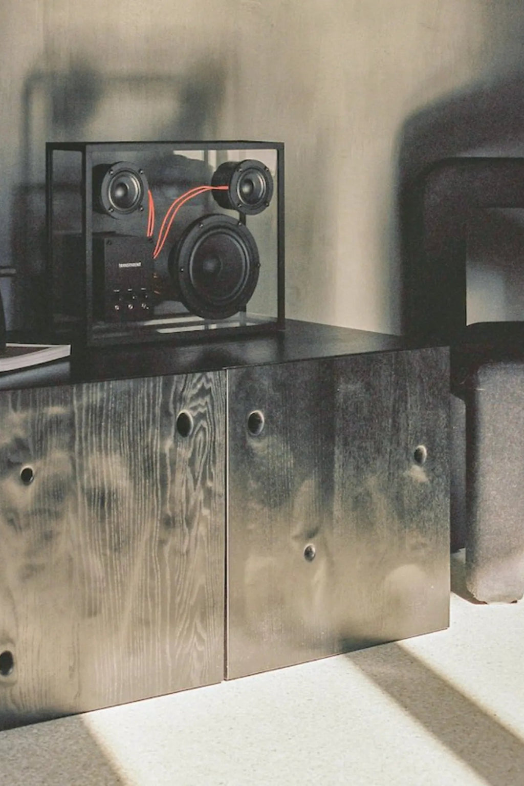 A transparent speaker in a minimalist home interior, blending seamlessly with the decor
###