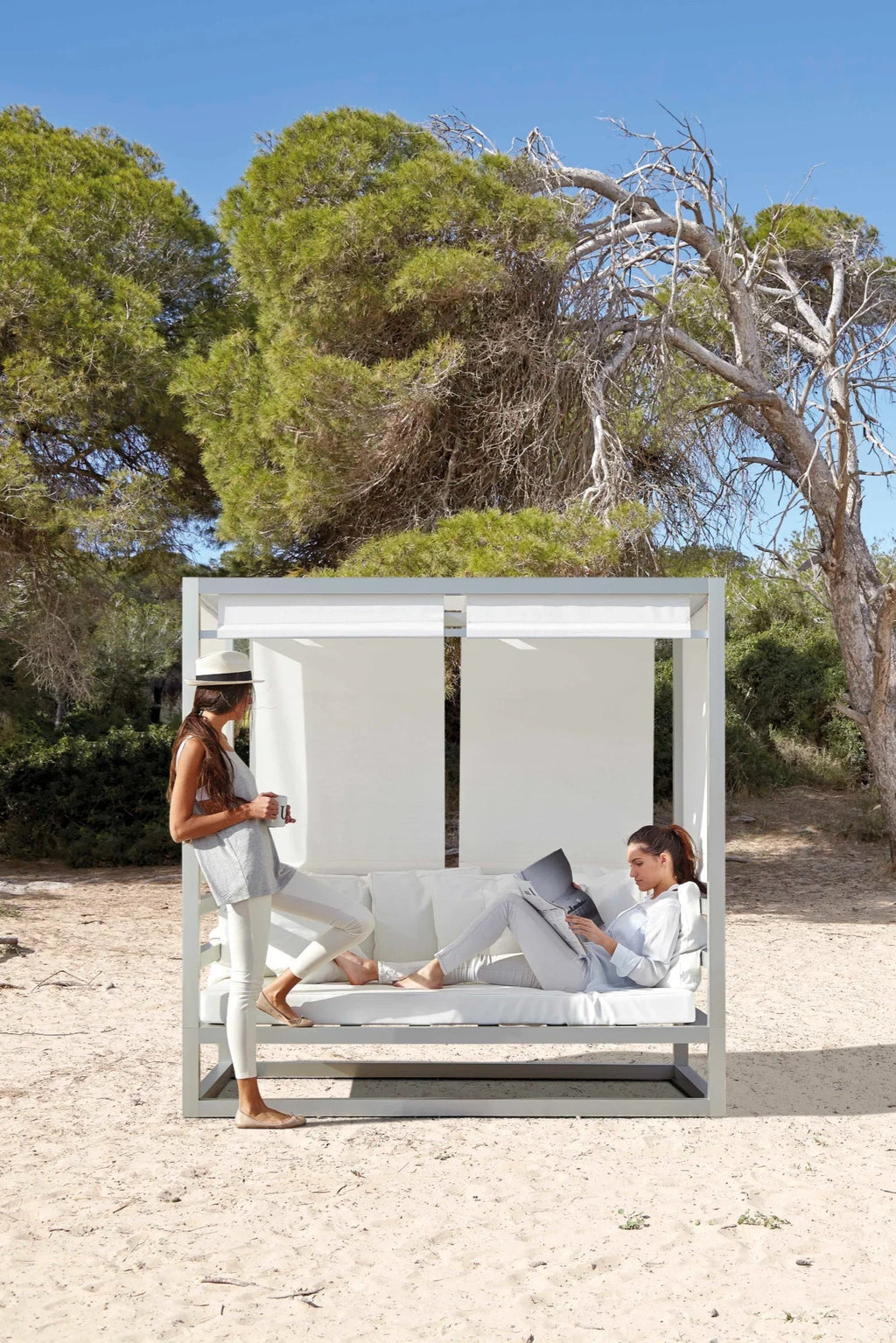 Gandia Blasco Tres Al Fresco Outdoor Sofa, a modern minimalist outdoor daybed featuring a sleek light grey powder-coated aluminum frame with plush white outdoor fabric cushions and retractable white fabric canopy panels. This contemporary outdoor sofa is perfect for luxury patio lounging, garden relaxation, or resort-style outdoor spaces.