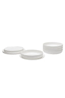 Set of white ceramic plates on a white background