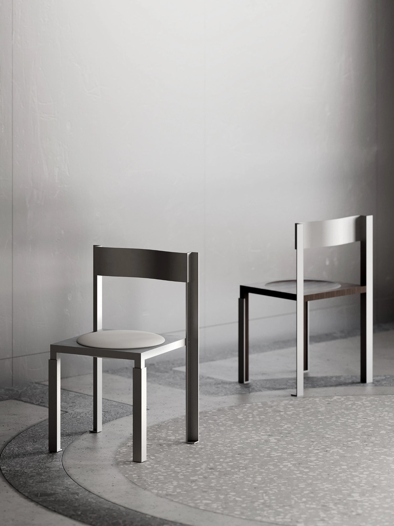 YET. Strut Chair, a modern minimalist dining chair crafted with a robust brushed metal frame in a sleek silver-grey finish. It features a bold, angular silhouette, a flat rectangular backrest, and a soft, round light cream upholstered seat cushion. A second chair in the background displays an alternative dark wood seat, offering a versatile option for contemporary dining rooms or industrial chic interiors.