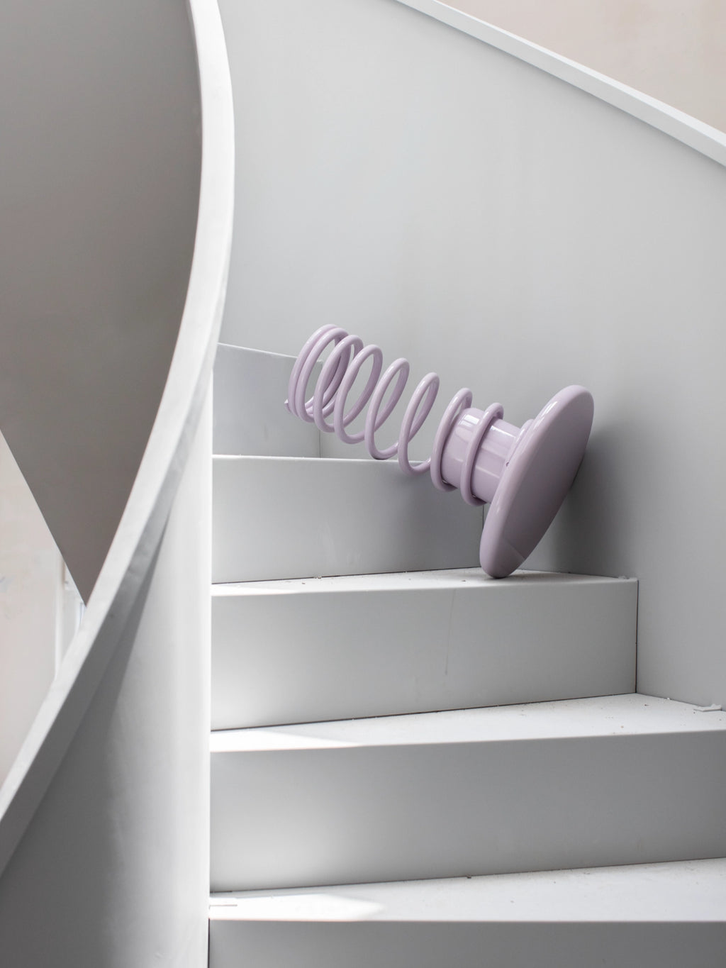 YET. Twist Stool, a playful contemporary accent stool with a high-gloss pale lavender lacquered finish, featuring a distinctive sculptural design with a whimsical coiled spring base and a smooth round top.