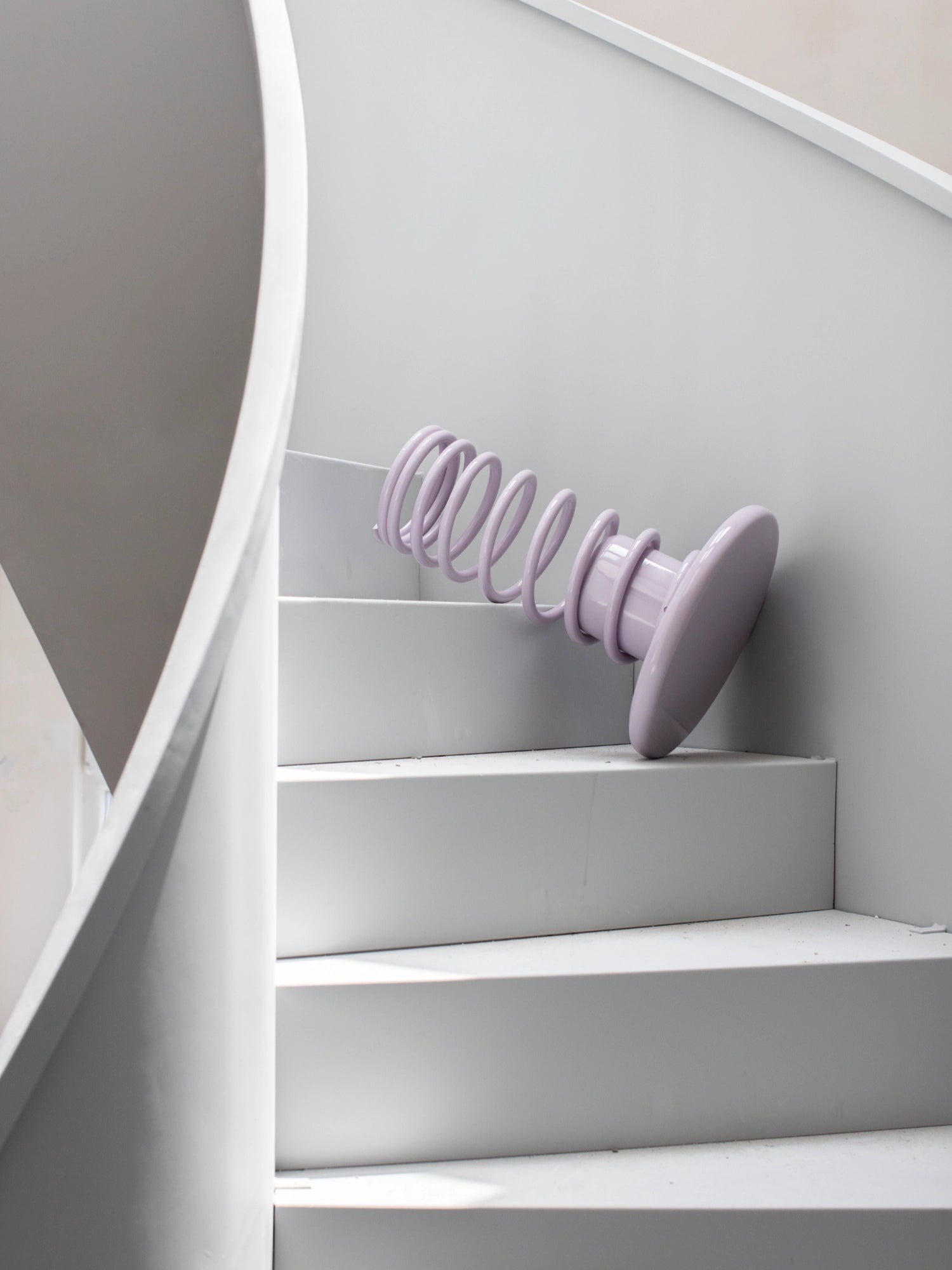 YET. Twist Stool, a playful contemporary accent stool with a high-gloss pale lavender lacquered finish, featuring a distinctive sculptural design with a whimsical coiled spring base and a smooth round top.