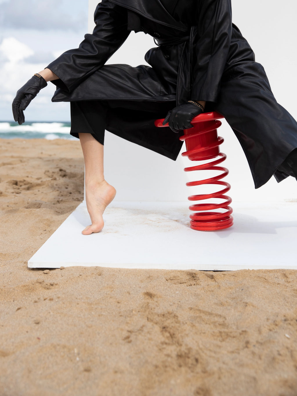 YET. Twist Stool, a striking contemporary accent stool featuring a vibrant red lacquered metal helical spring design that creates a playful and sculptural form. This unique metal coil stool serves as a bold statement piece of minimalist furniture, perfect for adding a pop of color to modern living rooms, creative workspaces, or art-inspired interiors.